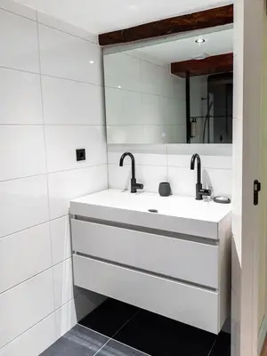 a bathroom with a sink and two faucets at Appartement Wolf in Alkmaar