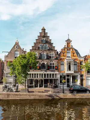 a large building next to a river in a city at Appartement Wolf in Alkmaar