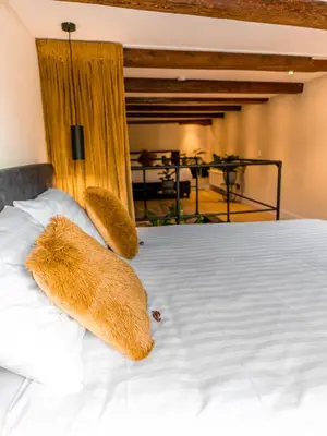 a teddy bear sitting on top of a bed at Appartement Wolf in Alkmaar