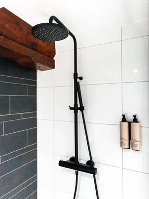 a shower with a black light in a bathroom at Appartement Wolf in Alkmaar