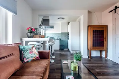 a living room with a couch and a table at Albatros aan Zee - Apartment in Zandvoort