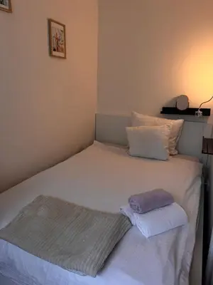 a bed with two towels sitting on top of it at Central B&B Apartment in Amsterdam in Amsterdam