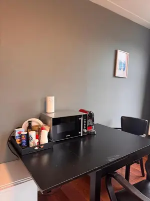 a black table with a microwave on top of it at Central B&B Apartment in Amsterdam in Amsterdam