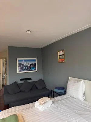 a bedroom with a bed and a couch at Central B&B Apartment in Amsterdam in Amsterdam