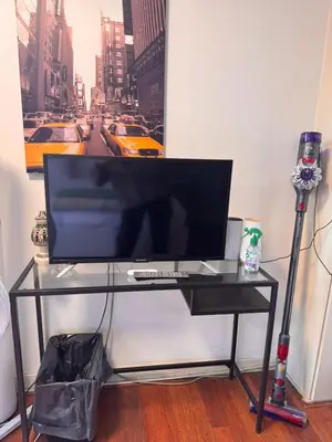 a computer monitor on a glass table in a room at Central B&B Apartment in Amsterdam in Amsterdam