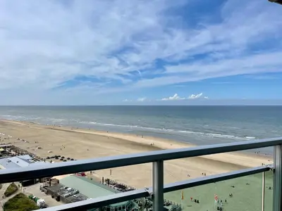 a view of the beach from a balcony at Zwarte Vis in Zandvoort