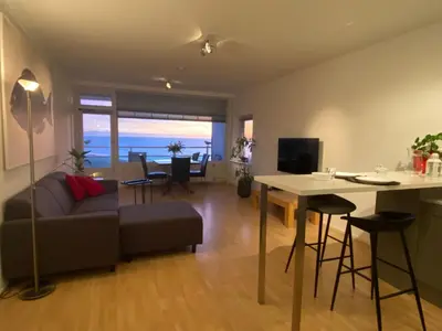 a living room with a couch and a table at Zwarte Vis in Zandvoort