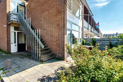 a brick building with a staircase on the side of it at The apartment Shell 42 in Zandvoort