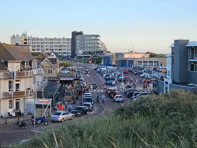 a busy city street filled with cars and people at Super de luxe privékamer op een toplocatie - Room 1 in Egmond aan Zee