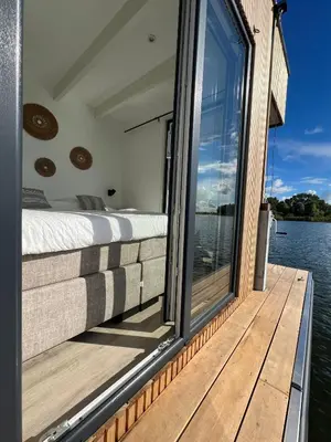 a bedroom on the back of a boat on the water at Surla houseboat 
