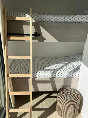 a room with a bunk bed and a wooden shelf at Surla houseboat 
