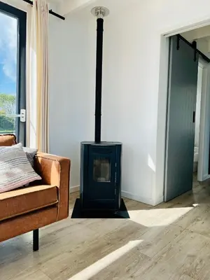 a fireplace in a living room with a couch at Surla houseboat 