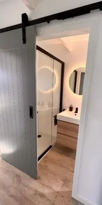a bathroom with a sliding door and a sink at Surla houseboat 