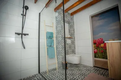 a bathroom with a shower with a toilet in it at Bed & Breakfast Bakker Meijer in Heemskerk