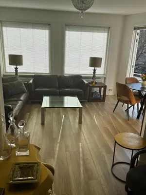 a living room with a couch and a table at AA Centrum Appartement in Zandvoort