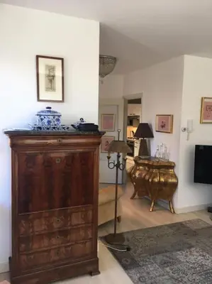 a living room with a large wooden cabinet and a television at AA Centrum Appartement in Zandvoort