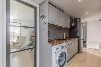 a kitchen with a washing machine in a room at Oase aan de Kaag in Warmond