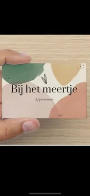 a hand holding a sign that reads by hot needle at Bij het meertje! in Dirkshorn