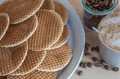 a plate of waffles and a cup of coffee at B&B De Beijersche Stee, Logies aan de Waterkant in Stolwijk