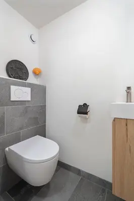 a bathroom with a white toilet and a sink at Family Stay Zandvoort - Free parking in Zandvoort