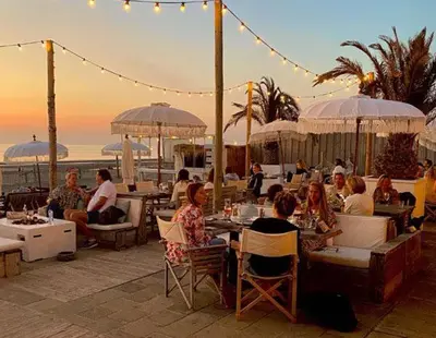 a group of people sitting at tables at a restaurant at Family Stay Zandvoort - Free parking in Zandvoort