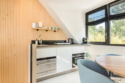 an open kitchen with a table and chairs at Berger Lodge in Alkmaar
