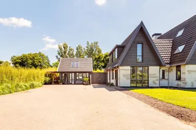 a house with a driveway in front of it at Berger Lodge in Alkmaar