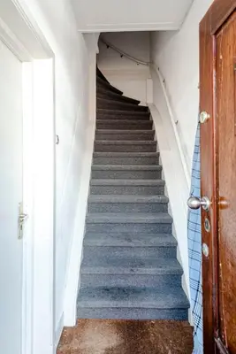 a staircase in a house with a blue and white stair case at Bluys Apartment in Zandvoort