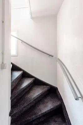 a staircase in a room with a stair railing at Bluys Apartment in Zandvoort