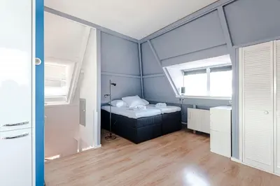 a small room with a bed and a window at Bluys Apartment in Zandvoort