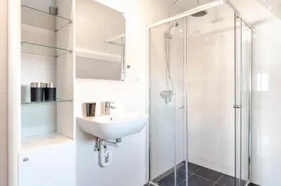 a bathroom with a sink and a shower at Bluys Apartment in Zandvoort