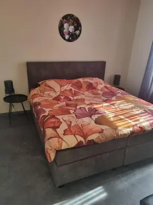 a bed in a bedroom with a blanket on it at Hemmer Hofstede in Hem