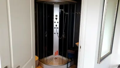 a bathroom with a shower with a toilet in it at Amor Guesthouse in Amsterdam