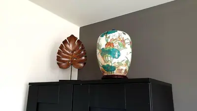 a vase sitting on top of a black cabinet at Amor Guesthouse in Amsterdam