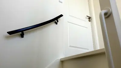 a white door with a black shelf on the wall at Amor Guesthouse in Amsterdam