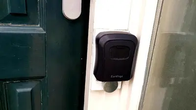 a black door knocker on a green door at Amor Guesthouse in Amsterdam