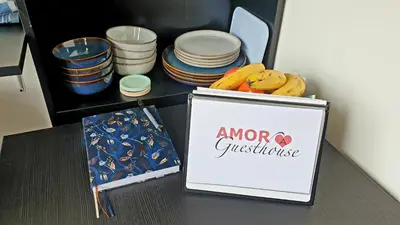 a sign on a table with a group of plates at Amor Guesthouse in Amsterdam