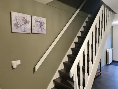 a staircase with two pictures of vases on the wall at Hemmer Hoeve in Hem