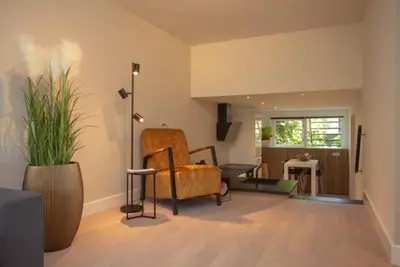 a living room with a couch and a chair at High Five in Zandvoort