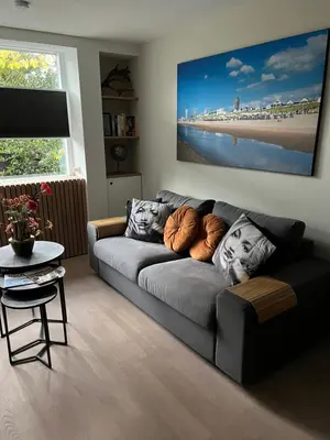 a living room with a couch and a table at High Five in Zandvoort