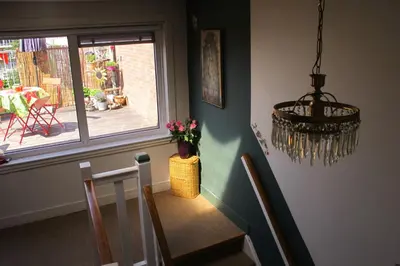a dining room with a table and a window at Wild Roses in Amsterdam