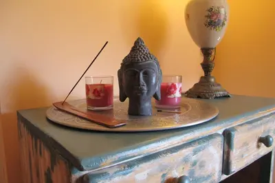 a tray with two glasses and a statue on a table at Wild Roses in Amsterdam