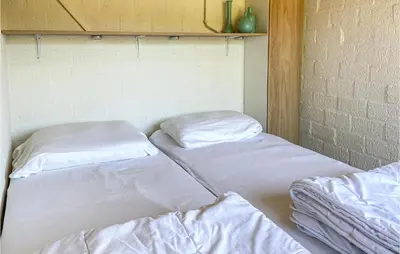 two beds in a room with white sheets at Nice Home In Warmenhuizen With Wifi in Schoorldam
