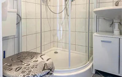 a bathroom with a shower with a toilet and a sink at Nice Home In Warmenhuizen With Wifi in Schoorldam