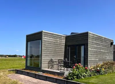 a black and gray house with a patio at Blossombed in Voorhout