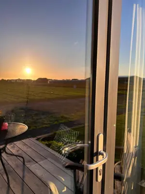 a view of the sunset from the balcony of a house at Blossombed in Voorhout