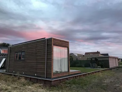 a small house with a window on top of a field at Blossombed in Voorhout