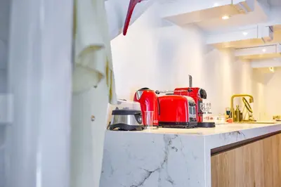 a red toaster sitting on a counter in a kitchen at Studio next to Skinny Bridge near Rembrandtsquare in Amsterdam