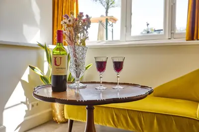 a table with two glasses and a bottle of wine at Studio next to Skinny Bridge near Rembrandtsquare in Amsterdam