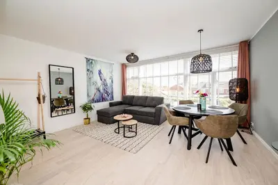 a living room with a couch and a table at Amsterdam Beach Apartment 52 in Zandvoort
